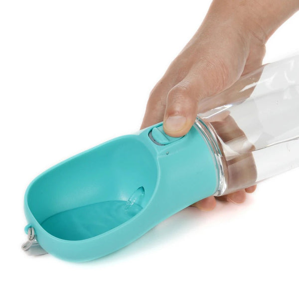 Turquoise pet water bottle with clear spout held by a hand on a white background